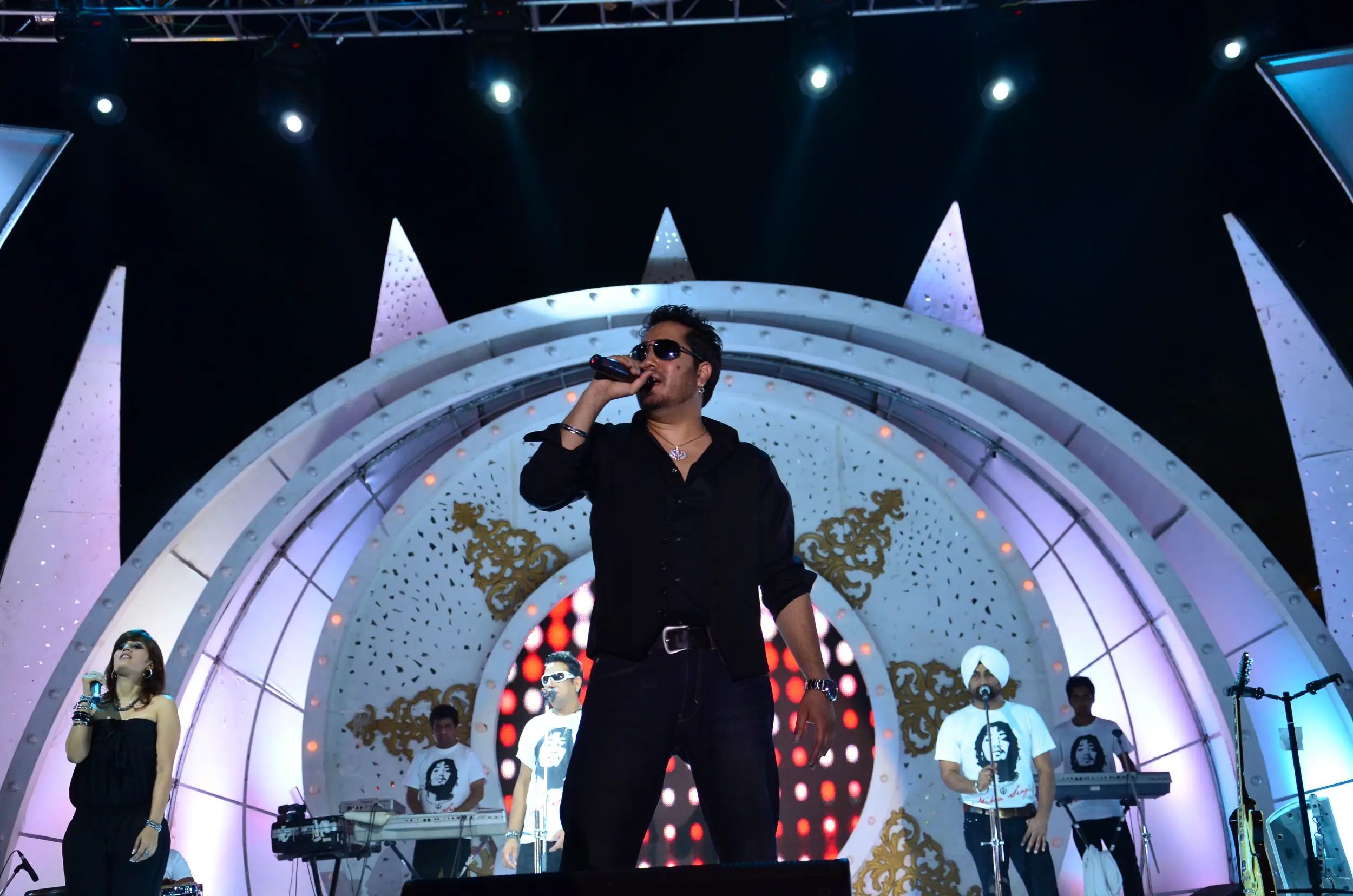 Festival Celebrations with people dancing on stage and colorful lighting
